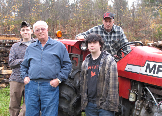A farm family by their tractor without a roll bar